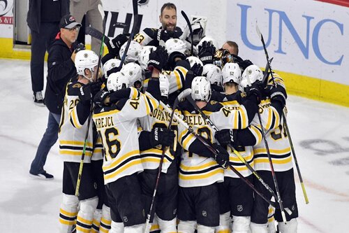 A group of Boston Bruin players celebrating on the ice after they beat the Canucks in the 2011 Stanley cup final