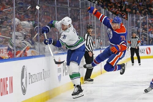 This is a picture of the Canucks against the Oilers for the NHL playoff picks article preview